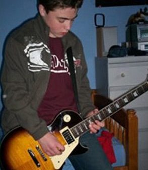 Teenage boy plays a guitar